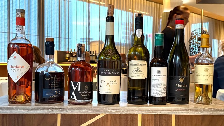 A selection of wine bottles displayed on a countertop in a restaurant setting.