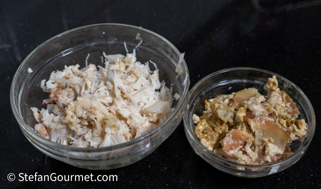 Two glass bowls containing different types of prepared seafood: one bowl with shredded crab meat and another with a mixture of seafood and egg.