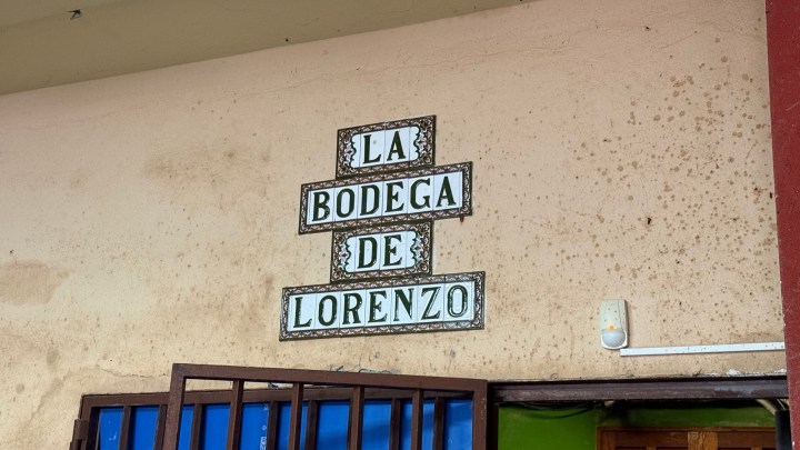 Sign on a wall reading 'La Bodega de Lorenzo' above an entrance.