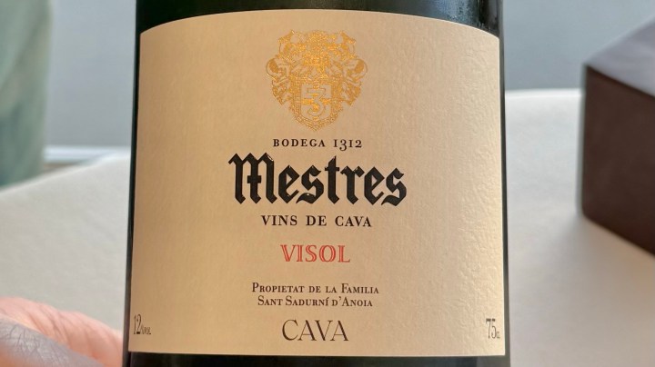 A close-up of a Cava wine bottle label from Bodega Mestres, featuring the name 'Visol' and details about the winery's heritage.